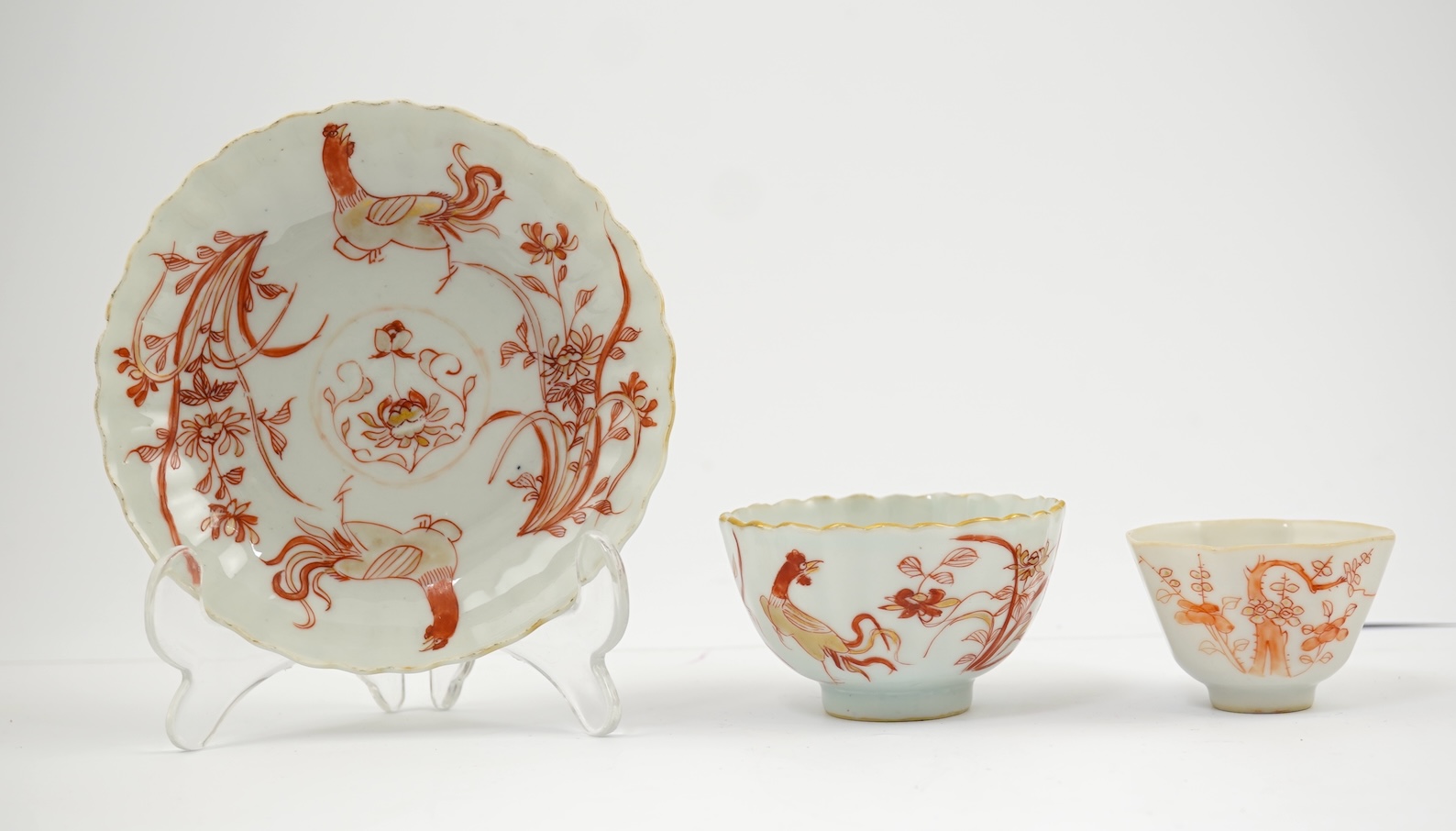 A Chinese rouge de fer tea bowl and saucer and a similar cup, Qianlong period